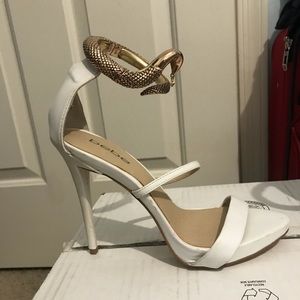 Brand new white with snake ankle Bebe stillettos